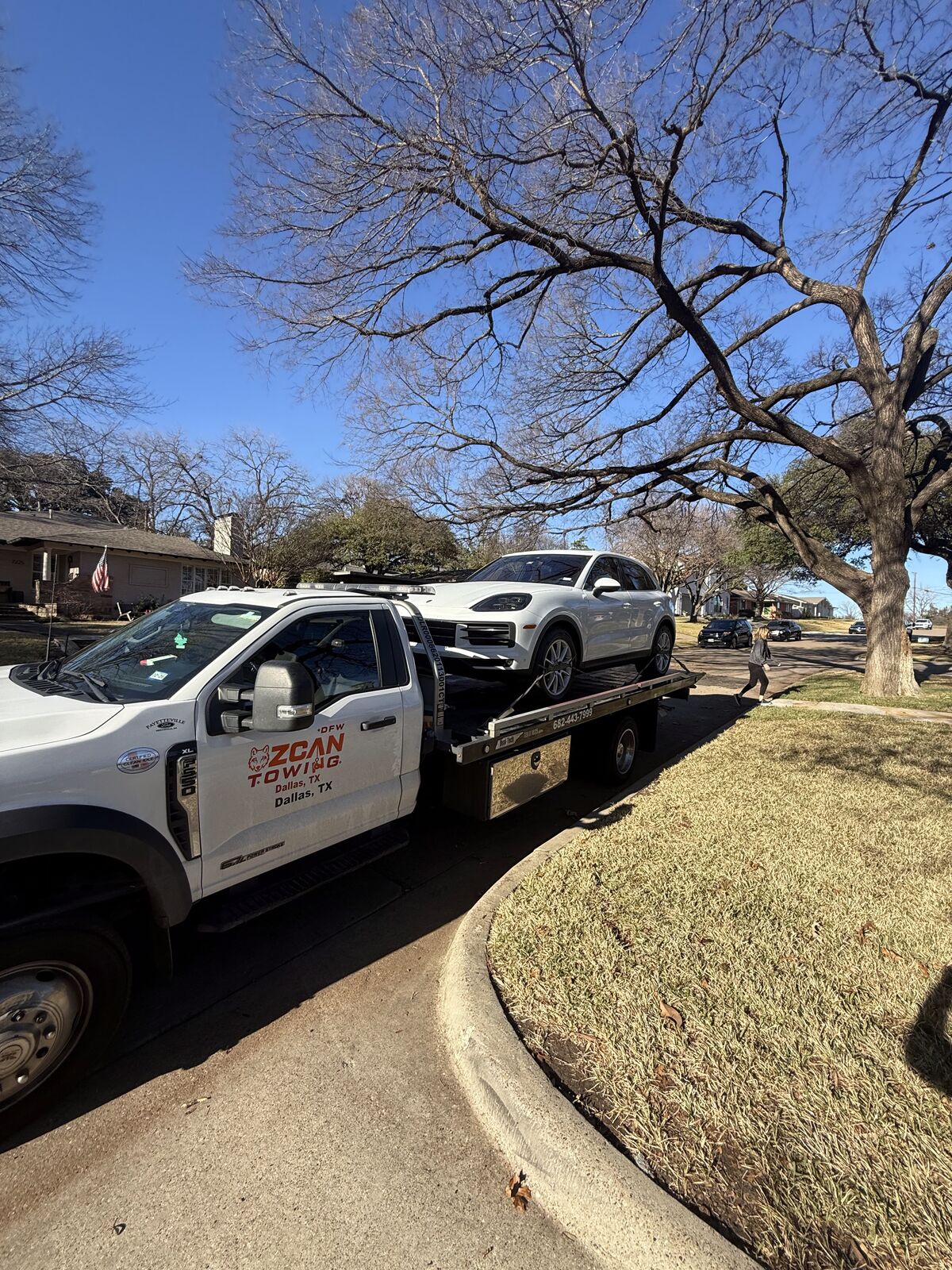 Ozcan Towing flatbed tow truck on a Dallas street